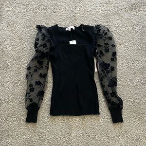 Black fitted shirt with flower lace detailing on the sleeves
